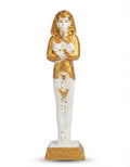 White and gold ancient Egyptian Osiris mummy figurine with traditional crossed flail and crook