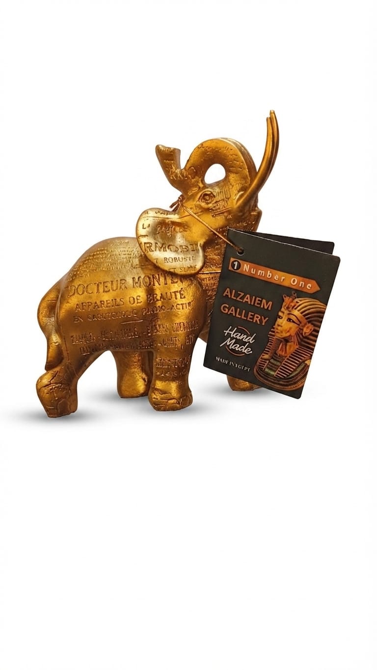Gold-finish elephant figurine with engraved text patterns and an Alzaiem Gallery tag