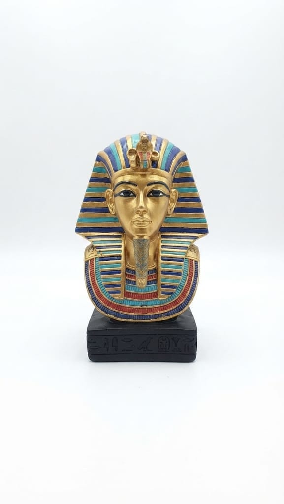 King Tutankhamun golden bust figurine with a turquoise and blue striped nemes headdress, detailed collar, and an inscribed black base