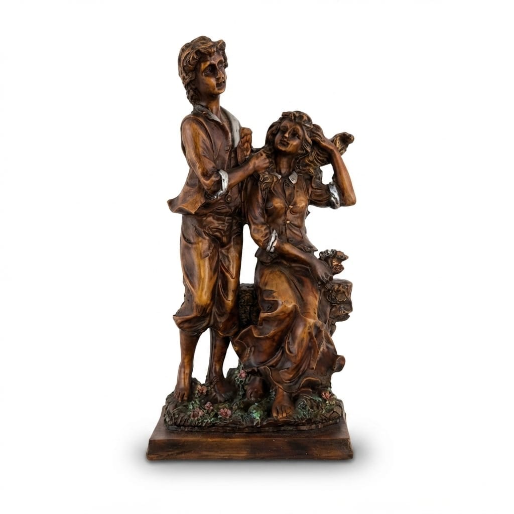Classic bronze-finish romantic figurine depicting a young man and woman in period attire standing and seated together on a stone bench