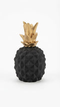Matte black pineapple figurine with a textured geometric pattern and a contrasting metallic gold top
