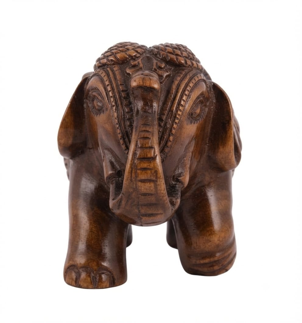 Hand-carved wooden elephant figurine with detailed traditional decorative motifs on its head and trunk