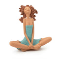 Terracotta-style meditating female figurine with flowing brown hair and wearing a turquoise-blue dress while seated cross-legged