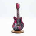Decorative wooden guitar-shaped desk figurine featuring a black-and-white portrait of Umm Kulthum and Arabic text
